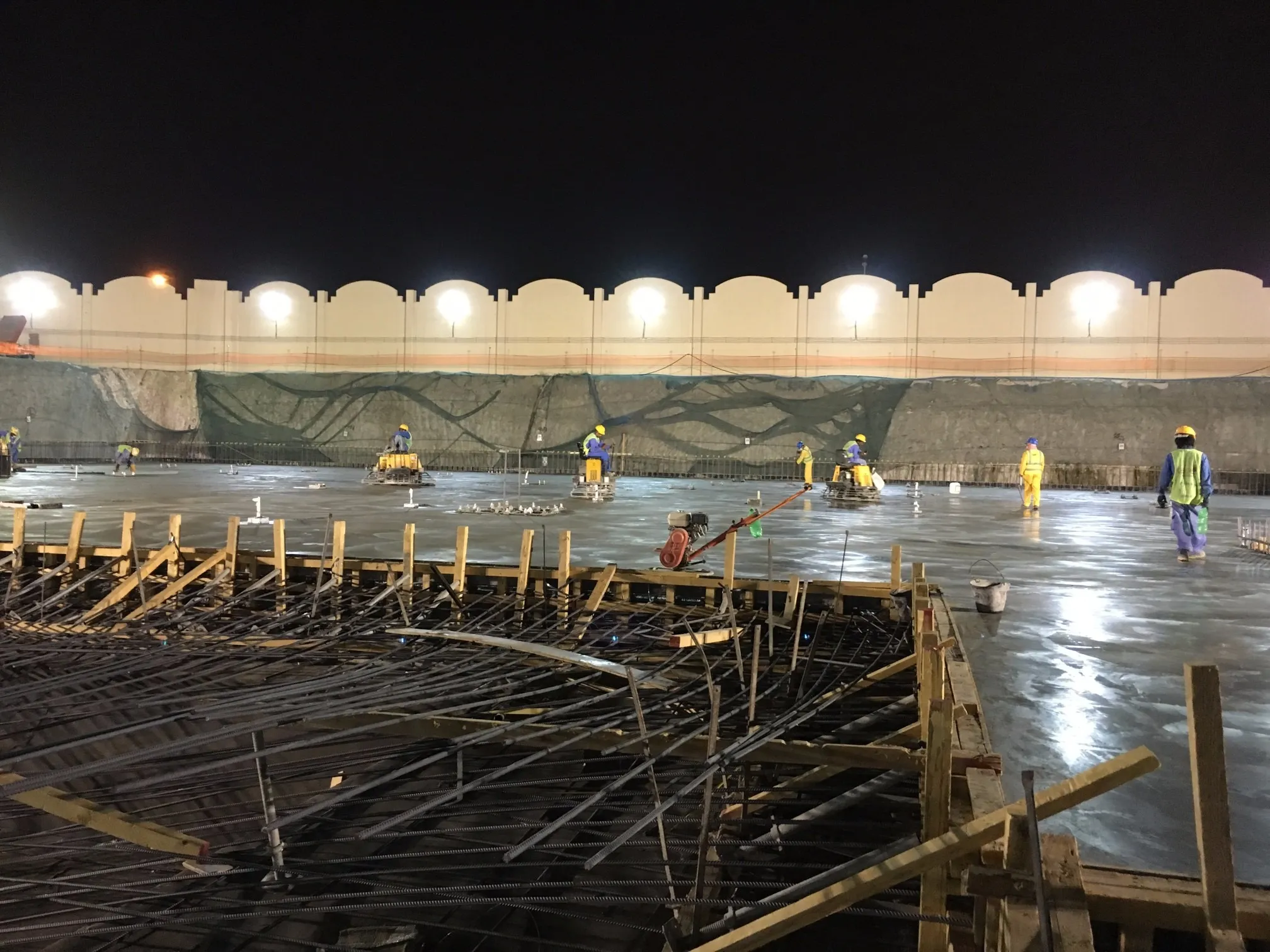 Night concrete pour under floodlights, Qatar